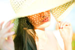 Девушка в шляпе, летнее фото с солнечными бликами на лице