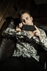 Фото юноши с айфоном в руках, лежа на диване, из мужского модельного портфолио